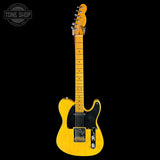 Yellow electric guitar on a black background with 'Tone Shop' logo.