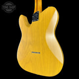 Yellow electric guitar body with 'Tone Shop' logo in the corner