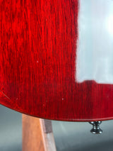 Close-up of a red guitar body with a blurred background