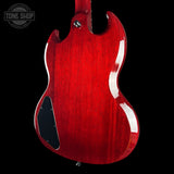 Red electric guitar body on a black background with 'Tone Shop' logo.