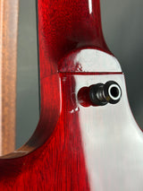 Close-up of a red and white guitar neck with a bolt.
