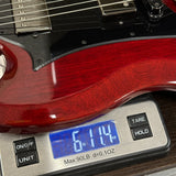 Guitar on a digital scale displaying weight