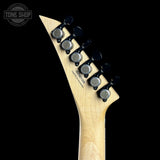 Guitar neck with tuning pegs on a black background, featuring the Tone Shop logo.