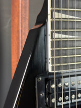 Close-up of a guitar's neck and headstock with brand name visible