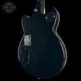 Black electric guitar body with 'Tone Shop' logo in the corner