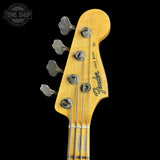 Close-up of a Fender Jazz Bass headstock in natural maple wood with four silver tuning pegs and a black Fender logo, shown against a solid black background.