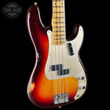 A vintage-style electric bass guitar with a sunburst finish transitioning from dark red to amber and black, featuring a cream-colored pickguard and maple neck, shown against a solid black background.