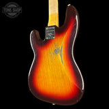 The back of a Fender Stratocaster electric guitar with a classic sunburst finish, showing a gradient from yellow-orange to dark red and black, photographed against a solid black background.