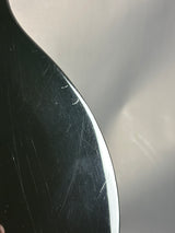 Scratched spoon on a reflective surface