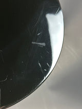 Scratched black surface with a reflective top