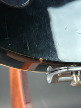 Close-up of a guitar with a scratch on the body