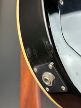 Close-up of a guitar's soundhole with a brand label.