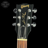 Gibson Les Paul guitar headstock with brand logo on a black background