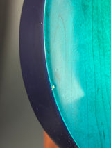 Small yellow object on a blue and black surface