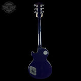 Blue electric guitar on a black background with 'Tone Shop' logo.