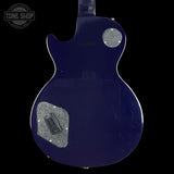 Back view of a blue electric guitar with 'Tone Shop' logo.
