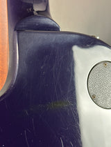 Scratched guitar with visible wear and tear