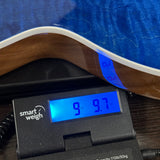 A close-up of a guitar body resting on a digital scale labeled 'smart weigh', showing a weight reading of 9.7 lbs (4.