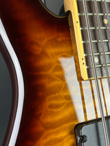 Close-up of a guitar's neck and body with a focus on the wood grain.