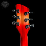 Close-up of the headstock of an electric guitar against a solid black background, showing six black tuning pegs and a glossy red-to-orange gradient finish. A 'TONE SHOP' watermark is visible in the top left corner.