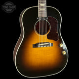 Acoustic guitar with a sunburst finish on a black background, featuring the Tone Shop logo.