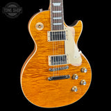 Electric guitar with a sunburst finish on a black background, featuring the Tone Shop logo.