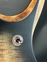 Close-up of a guitar's control knob with a wooden and metal design.