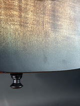 Close-up of a metallic surface with a knob on a dark background