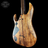 Wooden electric guitar body with a black background, featuring the Tone Shop logo.