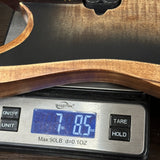 Wooden object on a digital scale displaying weight