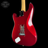 Red electric guitar with a visible brand logo on a black background
