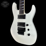 White electric guitar on a black background with 'Tone Shop' logo.