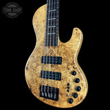 Wooden electric bass guitar with a visible brand logo on a black background