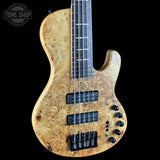 Electric bass guitar with a wood finish on a black background, featuring the Tone Shop logo.