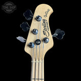 Bass guitar headstock with 'Sterling by Music Man' branding on a black background
