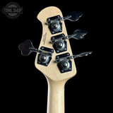 Close-up of a guitar headstock with tuning pegs on a black background, featuring the Tone Shop logo.