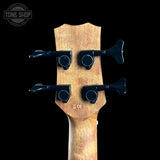 Wooden guitar headstock with tuning pegs on a black background, featuring 'Tone Shop' logo.