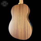 Back view of a wooden acoustic guitar with 'Tone Shop' logo.