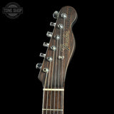Guitar headstock with Fender logo on a black background