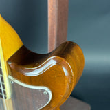 Close-up of a wooden guitar neck with a blurred background