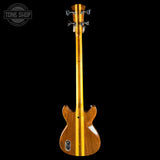 Wooden bass guitar with a visible brand logo on a black background
