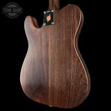 Wooden guitar body with a visible brand logo on a black background