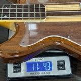 Wooden guitar on a digital scale displaying weight