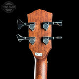 Wooden guitar headstock with tuning pegs on a black background, featuring 'Tone Shop' logo.