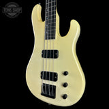 White bass guitar on a black background with 'Tone Shop' logo.