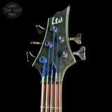 Close-up of a guitar headstock with 'Ltd' branding on a black background, featuring the Tone Shop logo.