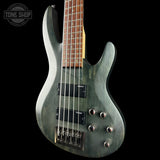 Green electric bass guitar with a black background, featuring the 'Tone Shop' logo.