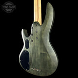 Electric bass guitar with a black finish on a dark background, featuring the Tone Shop logo.