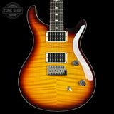 Electric guitar with a sunburst finish on a black background, featuring the Tone Shop logo.