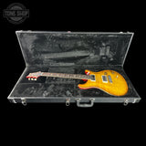 Electric guitar in a hard-shell case with 'Tone Shop' logo.